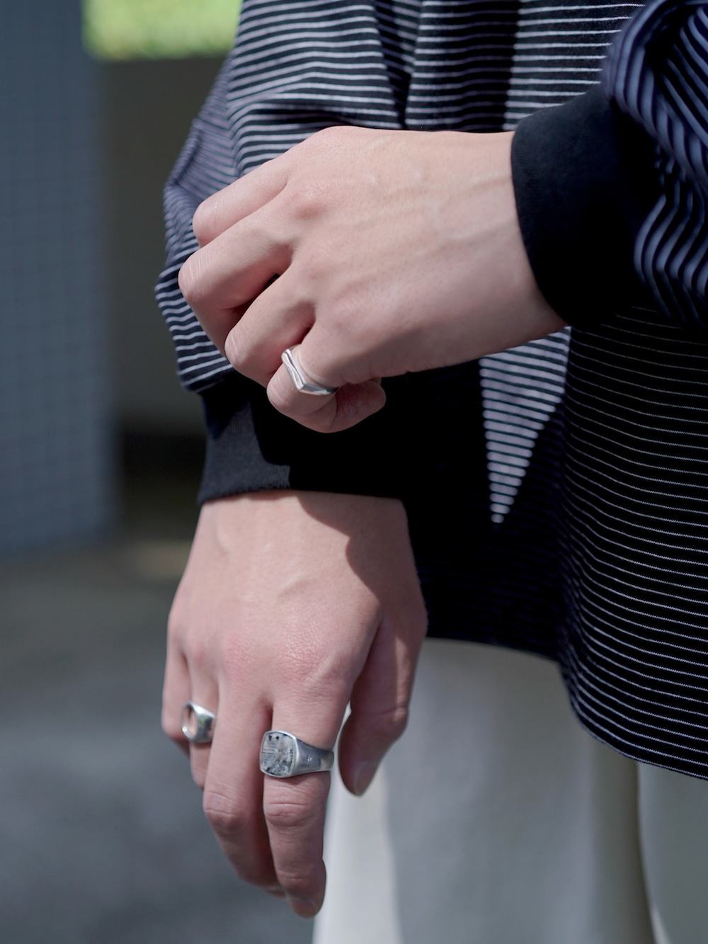 ホワイト系のチノパンツ、ホワイト系のトートバッグ、ブルー系のスニーカーを着用したメンズの春コーディネートの4枚目の写真