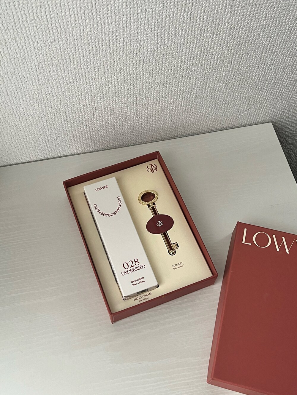 グリーン系の香水、ホワイト系のハンドケア/ハンドクリーム、レッド系のハンドケア/ハンドクリームを着用したレディースの夏コーディネートの3枚目の写真