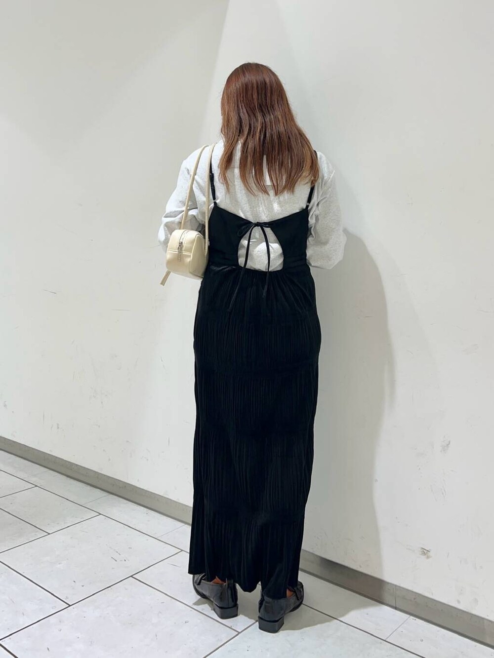 グレー系のTシャツ/カットソー、ブラック系のローファー、ブラック系のワンピースを着用したレディースの秋コーディネートの3枚目の写真