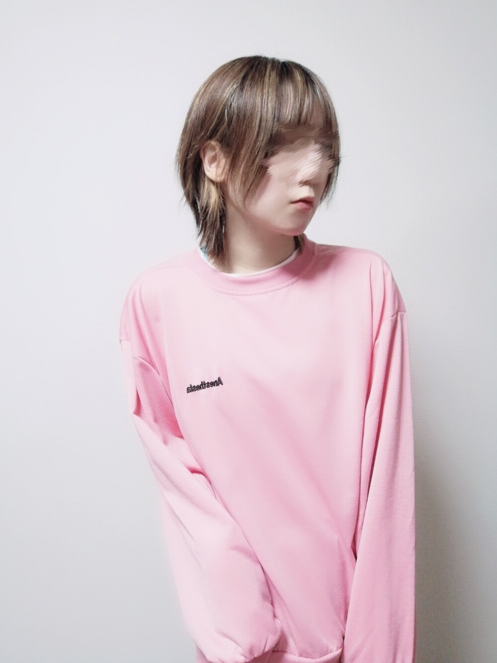 ピンク系のスウェット、ブルー系のデニムパンツを着用したレディースの冬コーディネートの2枚目の写真