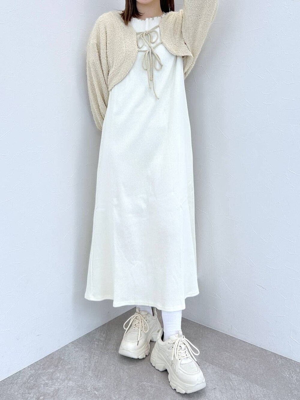 ホワイト系のスニーカー、その他のピアス（両耳用）を着用したレディースの冬コーディネートの3枚目の写真