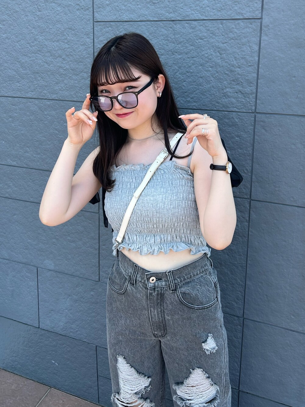 グレー系のその他トップス、ブラック系のデニムパンツ、ホワイト系のショルダーバッグを着用したレディースの夏コーディネートの3枚目の写真