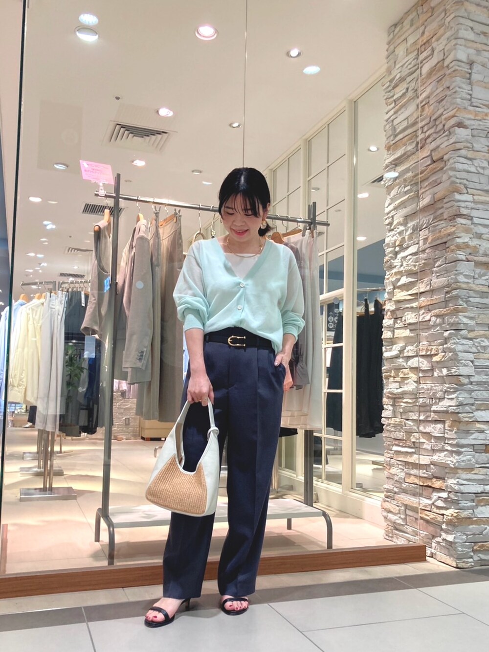 ホワイト系のテーラードジャケット、グレー系のその他パンツ、ホワイト系のかごバッグを着用したレディースの春コーディネートの3枚目の写真