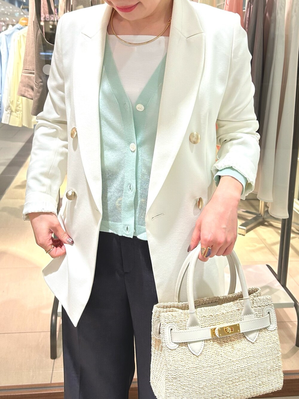 ホワイト系のテーラードジャケット、グレー系のその他パンツ、ホワイト系のかごバッグを着用したレディースの春コーディネートの2枚目の写真