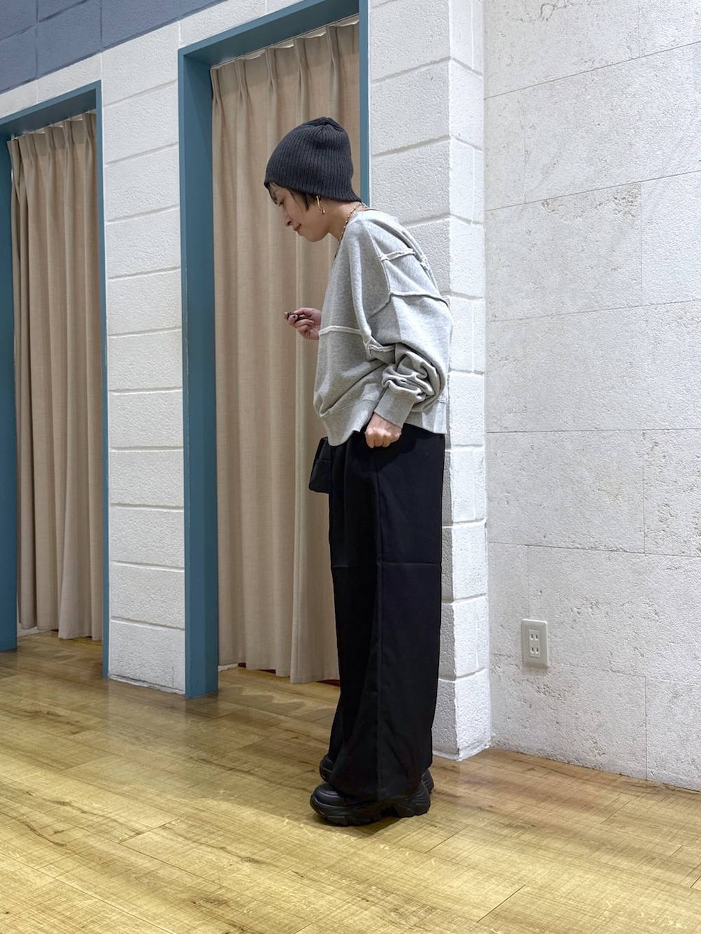 ブラック系のブーツ、グレー系のスウェット、ブラック系のショルダーバッグを着用したレディースの冬コーディネートの5枚目の写真