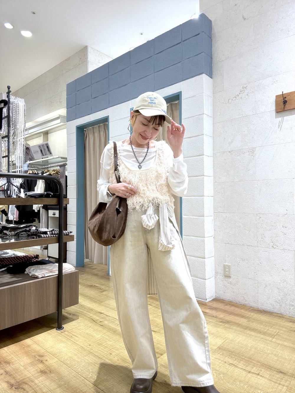 ホワイト系のTシャツ/カットソー、ベージュ系のデニムパンツ、ブラウン系のサンダルを着用したレディースの春コーディネートの7枚目の写真