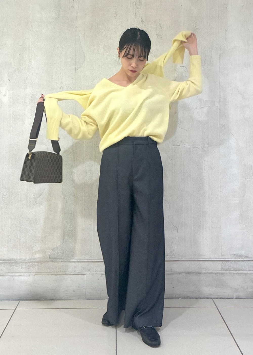イエロー系のカーディガン/ボレロ、イエロー系のニット/セーター、ブルー系のその他パンツを着用したレディースの秋コーディネートの6枚目の写真