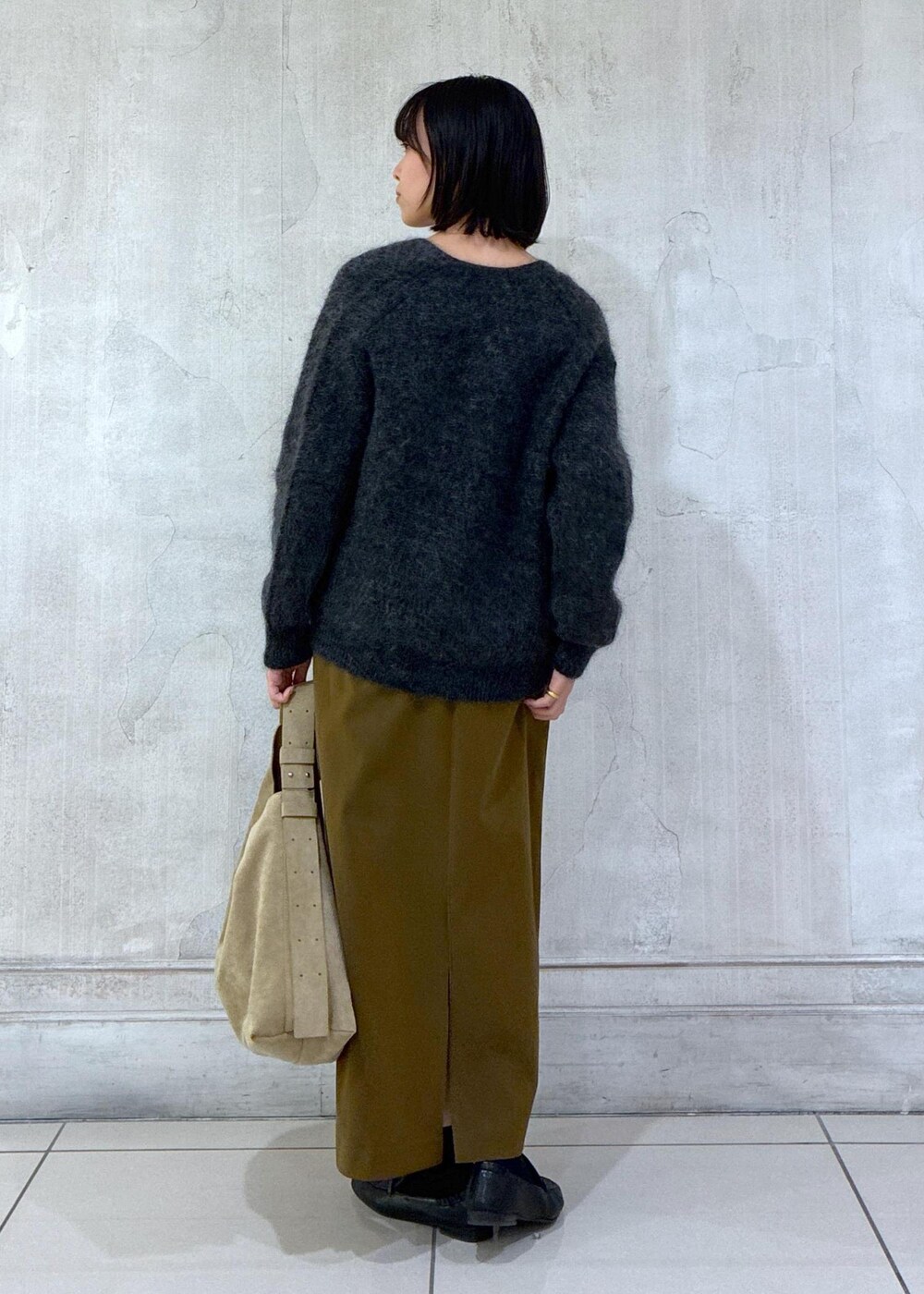 グレー系のカーディガン/ボレロ、ブラウン系のワンピース、ベージュ系のショルダーバッグを着用したレディースの冬コーディネートの4枚目の写真