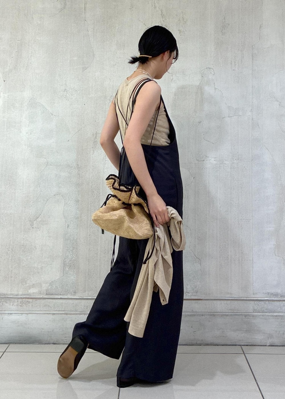 ブラック系のパンプス、ベージュ系のカーディガン/ボレロ、ベージュ系のタンクトップを着用したレディースの春コーディネートの6枚目の写真