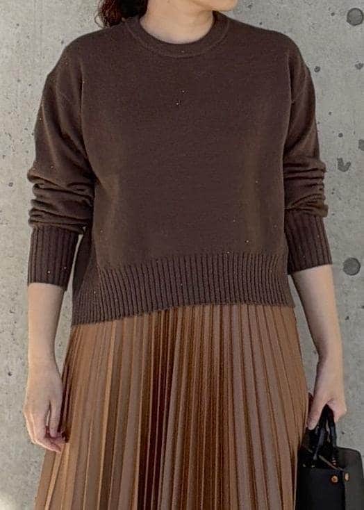 ブラック系のハンドバッグ、イエロー系のスカート、ブラウン系のニット/セーターを着用したレディースの冬コーディネートの4枚目の写真