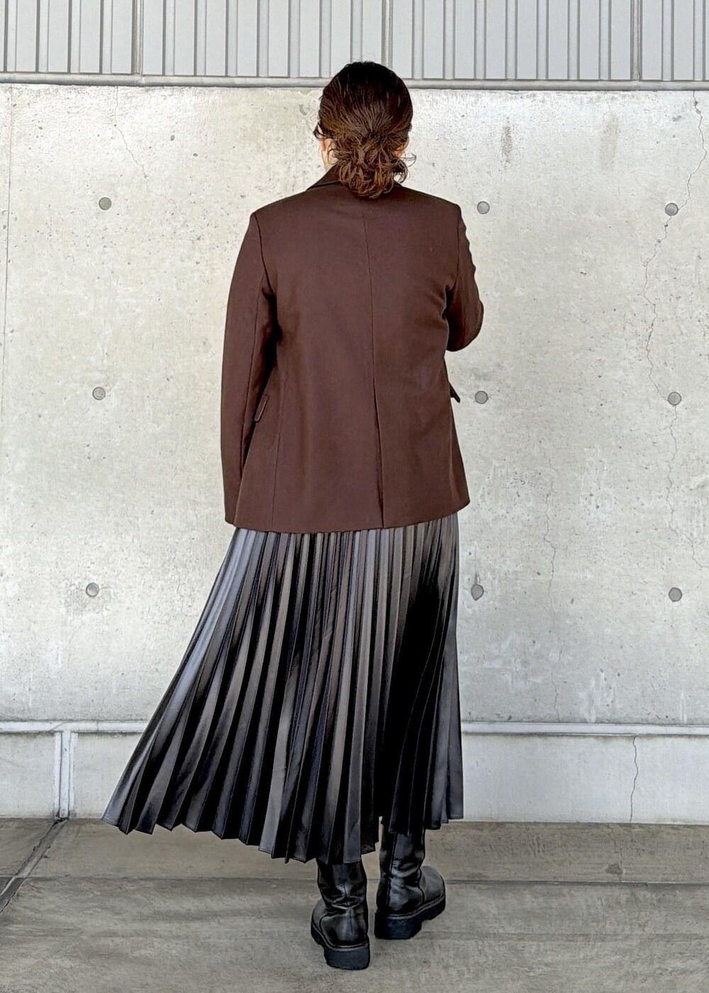 ブラウン系のハンドバッグ、ブラック系のカーディガン/ボレロ、ブラック系のスカートを着用したレディースの秋コーディネートの3枚目の写真