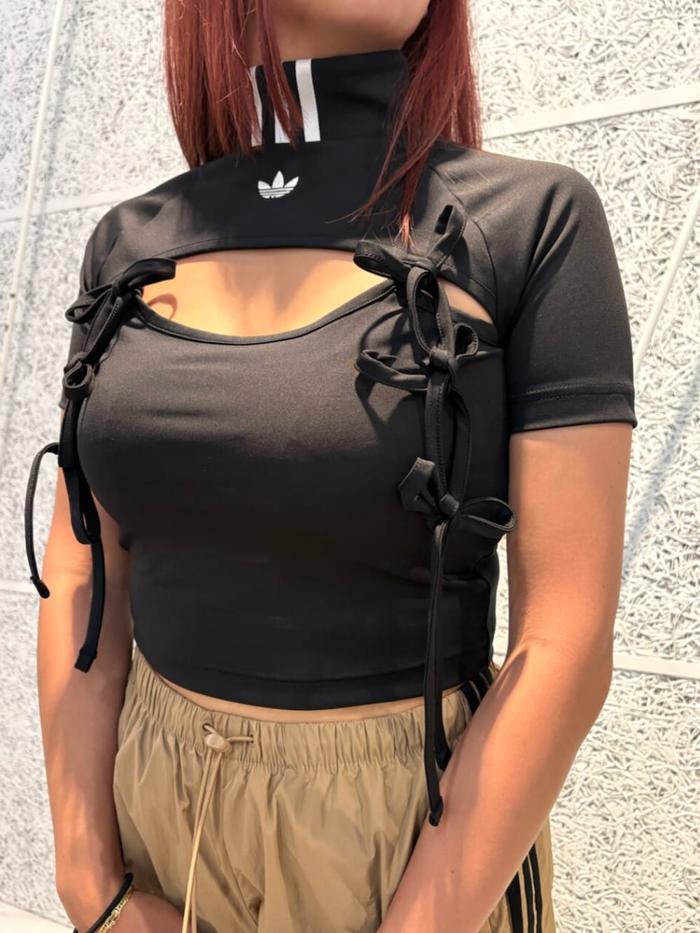 ピンク系のスニーカー、ブラック系のTシャツ/カットソー、ブラウン系のパンツを着用したレディースの夏コーディネートの3枚目の写真