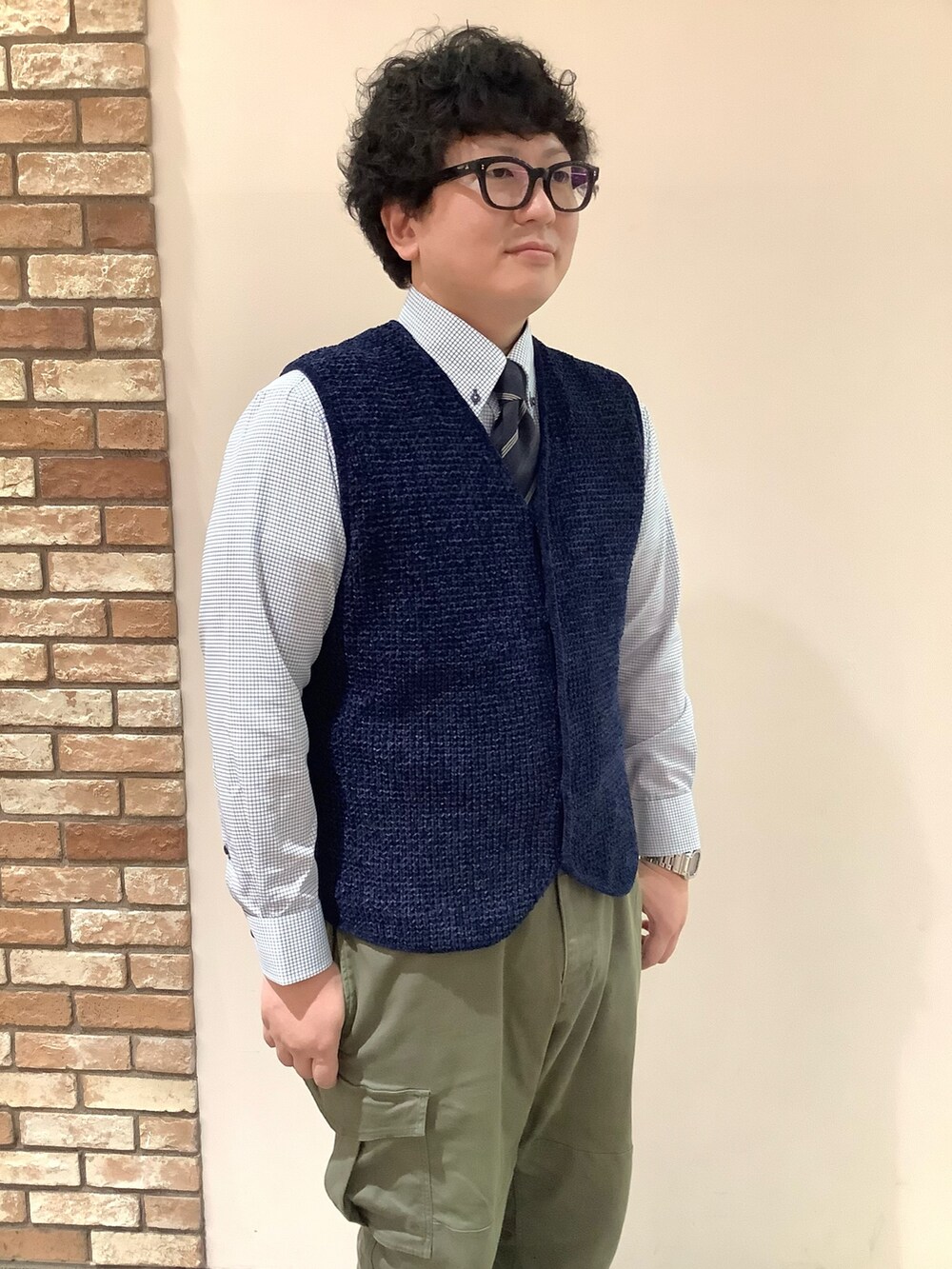ブルー系のベスト、ブルー系のビジネスシャツを着用したメンズの秋コーディネートの2枚目の写真