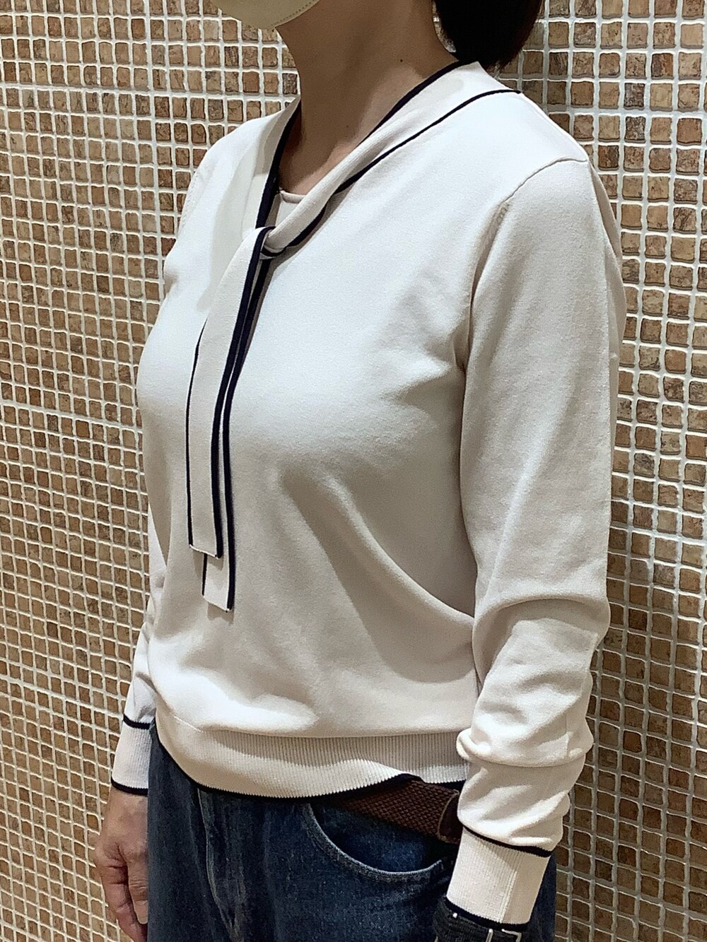 ホワイト系のニット/セーターを着用したレディースの秋コーディネートの2枚目の写真