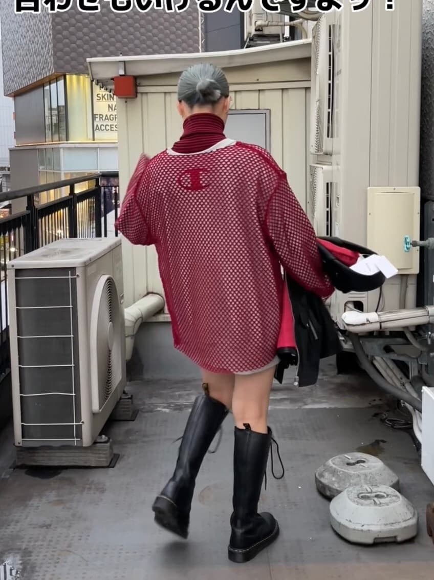 ブラック系のブーツ、ブルー系のデニムパンツ、レッド系のニット/セーターを着用したレディースの秋コーディネートの2枚目の写真