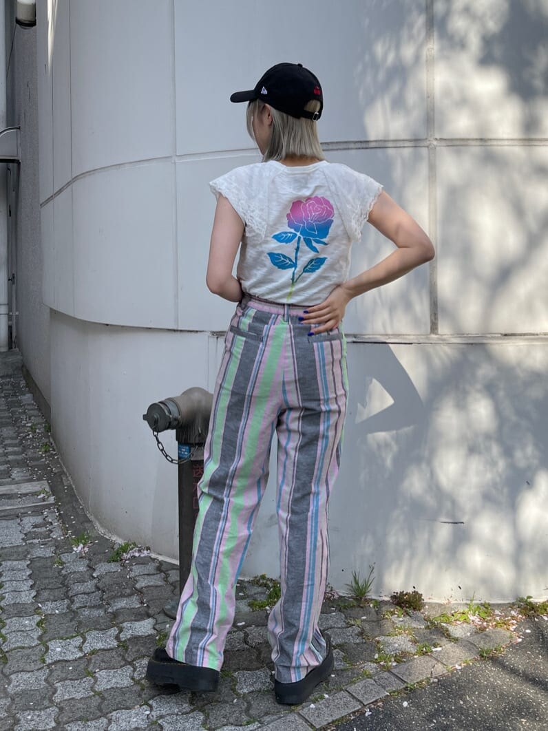 ブラック系のその他シューズ、ブラック系のスラックス、ホワイト系のTシャツ/カットソーを着用したレディースの春コーディネートの4枚目の写真