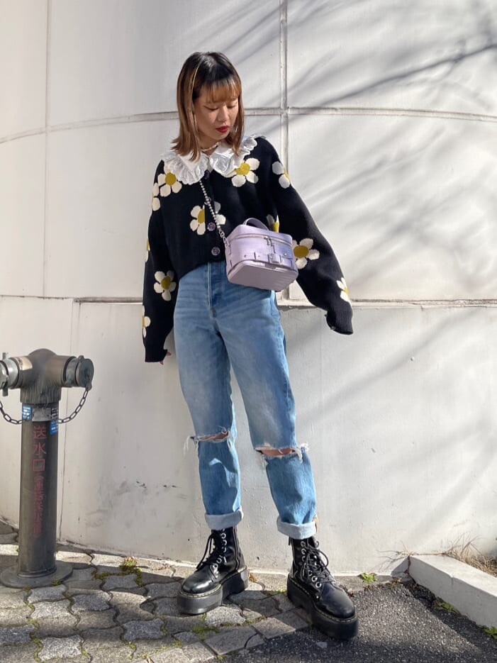 ブルー系のデニムパンツ、ホワイト系のシャツ/ブラウス、パープル系のショルダーバッグを着用したレディースの冬コーディネートの2枚目の写真