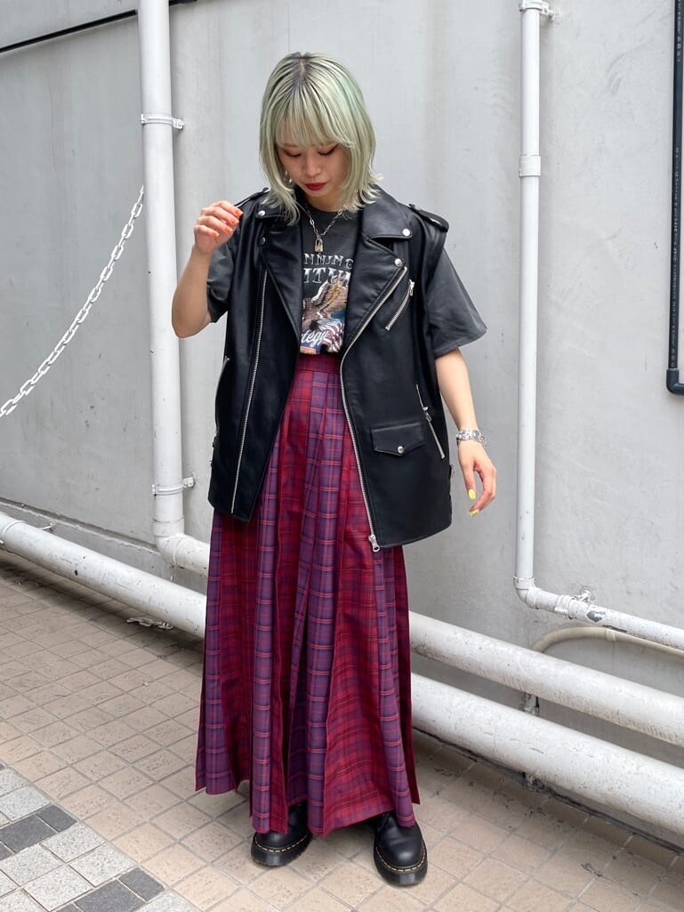 ブラック系のブーツ、レッド系のスカート、ブラック系のTシャツ/カットソーを着用したレディースの夏コーディネートの2枚目の写真