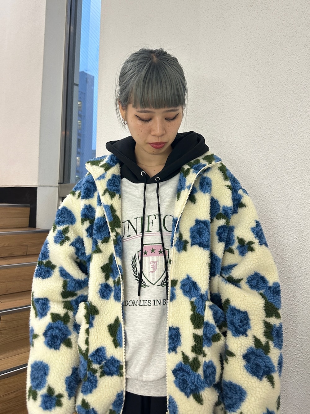 ホワイト系のブルゾン、グレー系のパーカー、ブラック系のその他パンツを着用したレディースの秋コーディネートの4枚目の写真