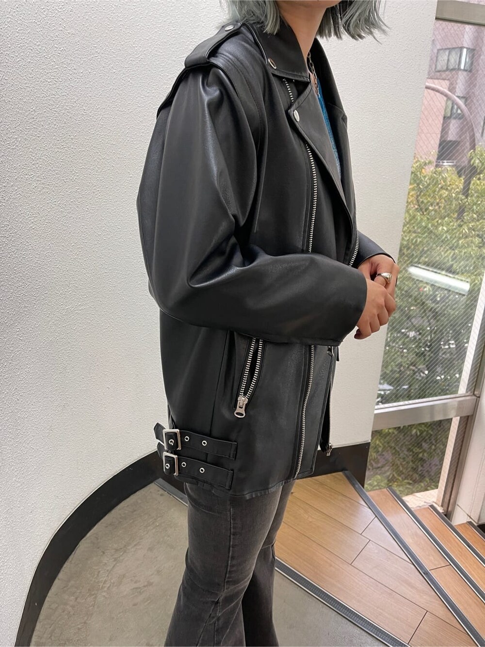 ブラック系のブーツ、ブラック系のライダースジャケット、ブルー系のカーディガン/ボレロを着用したレディースの秋コーディネートの9枚目の写真