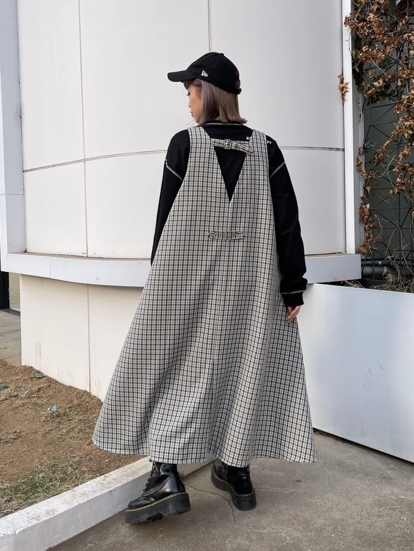 ブラック系のデニムパンツ、その他のジャンパースカート、ブラック系のショルダーバッグを着用したレディースの冬コーディネートの5枚目の写真