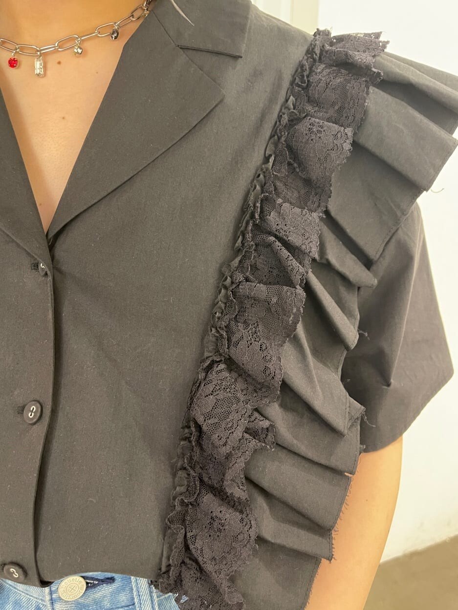 ブラック系のシャツ/ブラウス、ブラック系のサンダル、ブルー系のデニムパンツを着用したレディースの春コーディネートの8枚目の写真