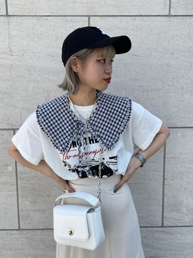 ブラック系のブーツ、ホワイト系のハンドバッグ、ホワイト系のTシャツ/カットソーを着用したレディースの夏コーディネートの3枚目の写真
