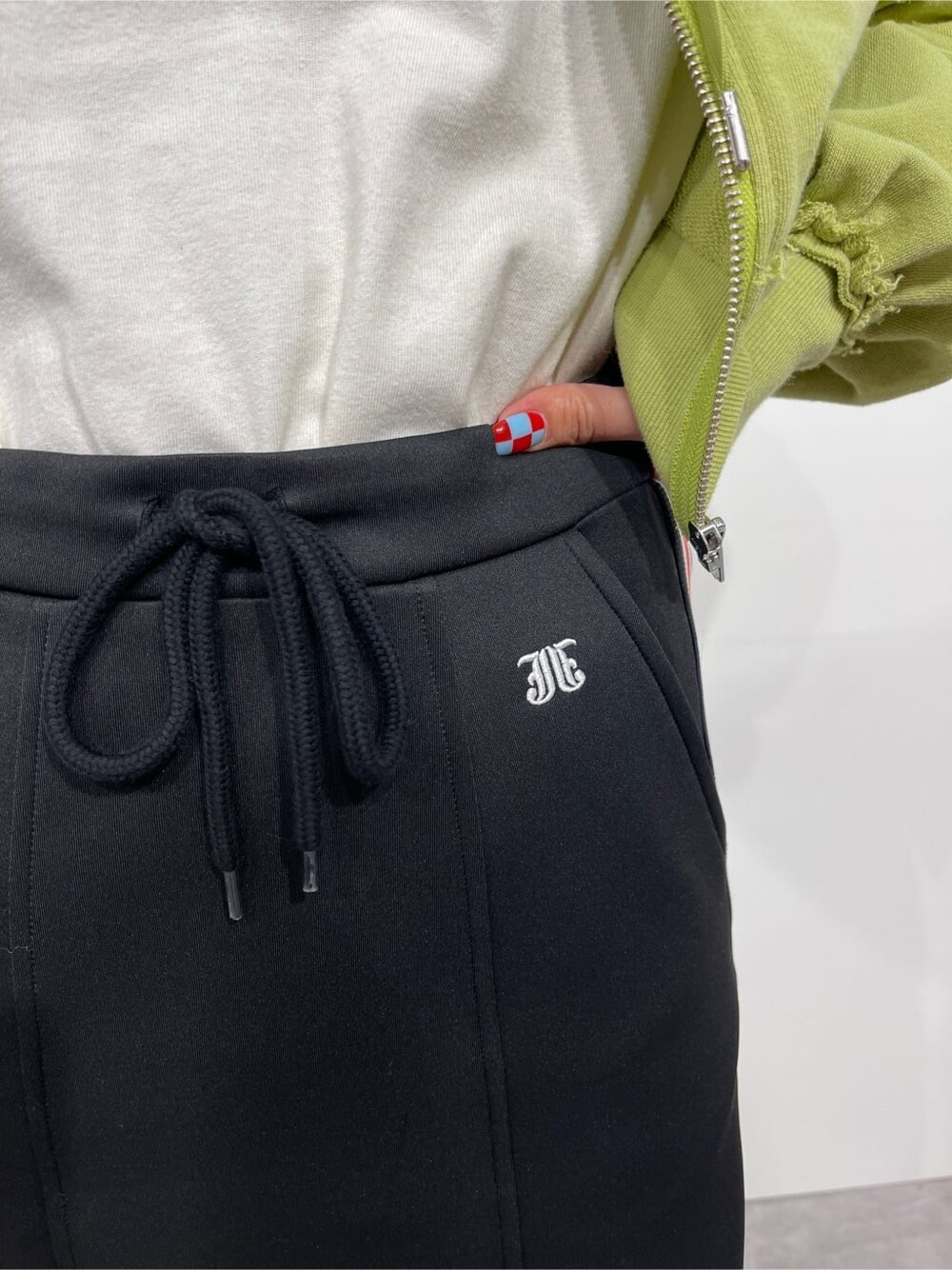 ホワイト系のTシャツ/カットソー、グリーン系のパーカー、レッド系のスカートを着用したレディースの秋コーディネートの6枚目の写真