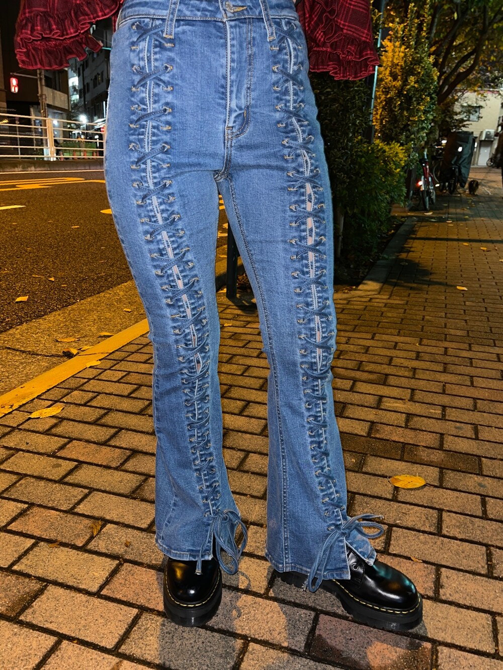 レッド系のシャツ/ブラウス、ブラック系のTシャツ/カットソー、ブルー系のデニムパンツを着用したレディースの秋コーディネートの7枚目の写真