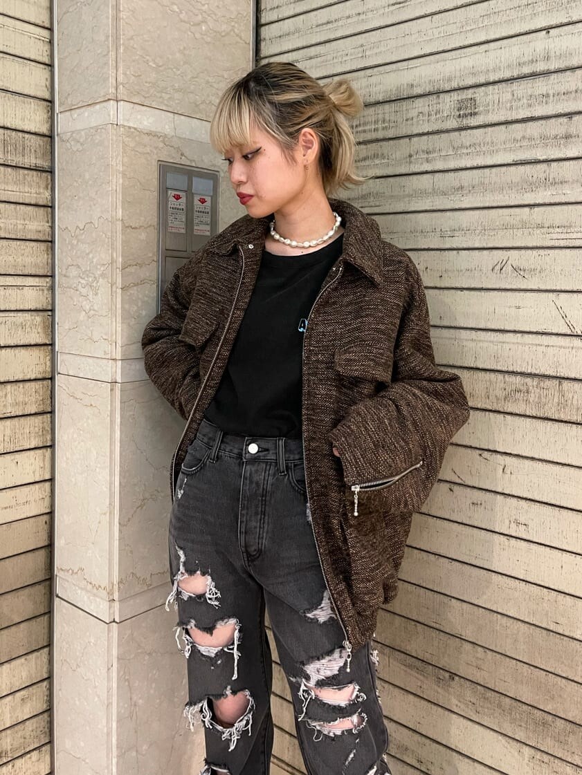 ブラック系のブーツ、ブラック系のデニムパンツ、ブラウン系のブルゾンを着用したレディースの夏コーディネートの5枚目の写真