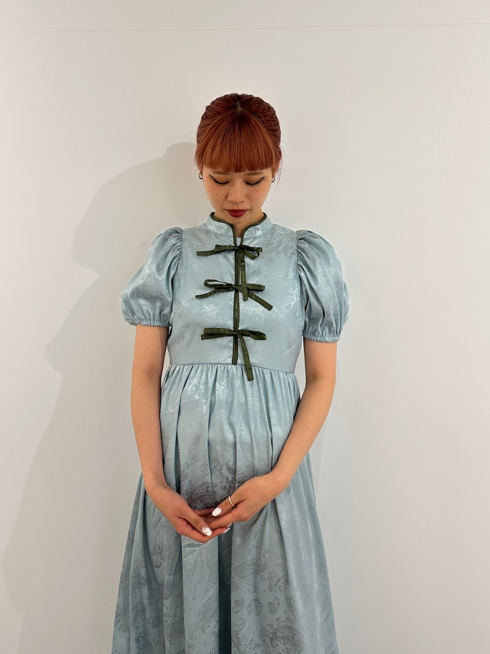 ブルー系のワンピース、ブラック系のブーツを着用したレディースの春コーディネートの4枚目の写真