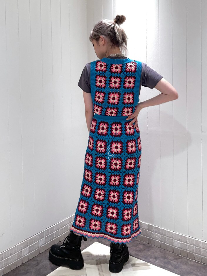 ブラック系のブーツ、ブルー系のスカート、ブルー系のベストを着用したレディースの春コーディネートの2枚目の写真