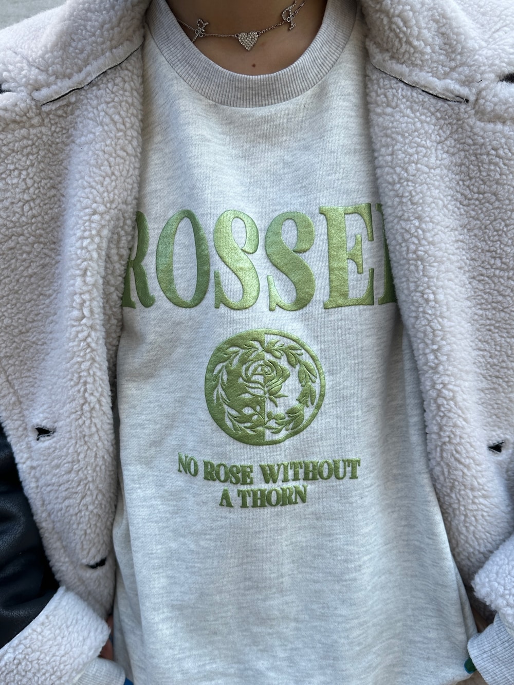 ブラック系のムートンコート、グレー系のスウェット、グリーン系のワンピースを着用したレディースの冬コーディネートの6枚目の写真