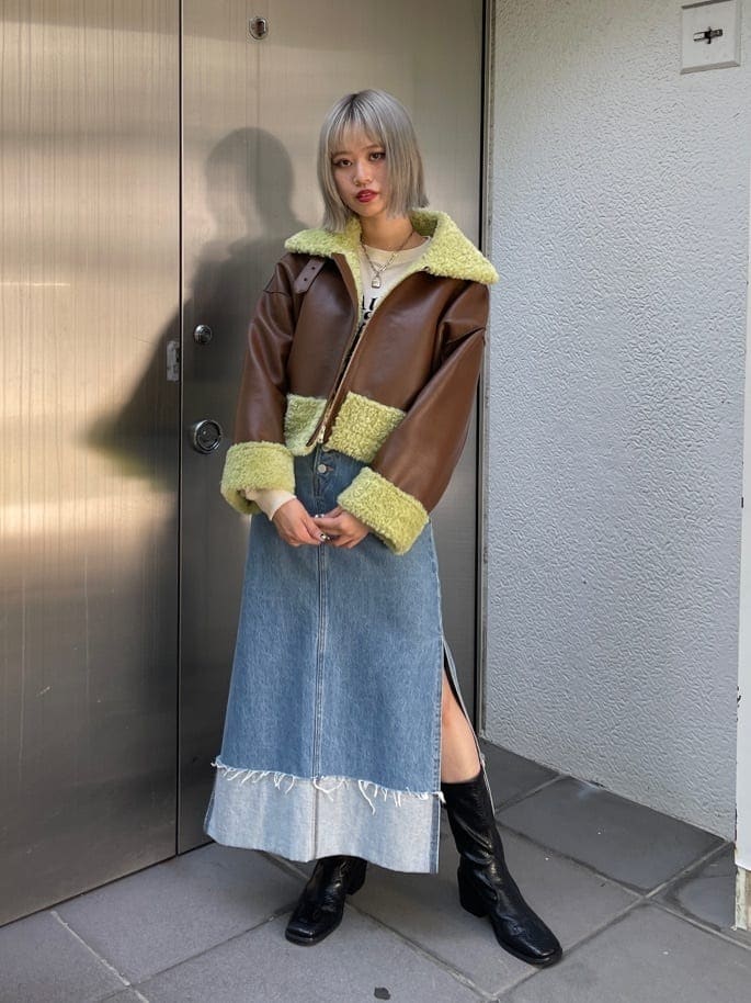 ブラック系のブーツ、ブラウン系のその他アウター、ブルー系のデニムスカートを着用したレディースの夏コーディネートの4枚目の写真