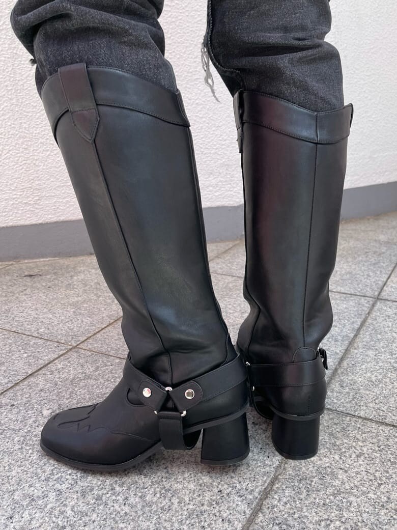 ブラック系のブーツ、ブラック系のデニムパンツ、オレンジ系のカーディガン/ボレロを着用したレディースの夏コーディネートの8枚目の写真