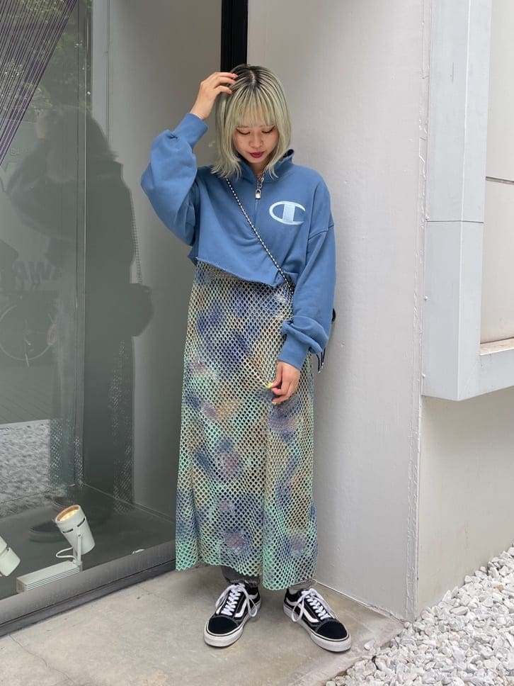 グリーン系のワンピース、ブルー系のスウェットを着用したレディースの秋コーディネートの2枚目の写真