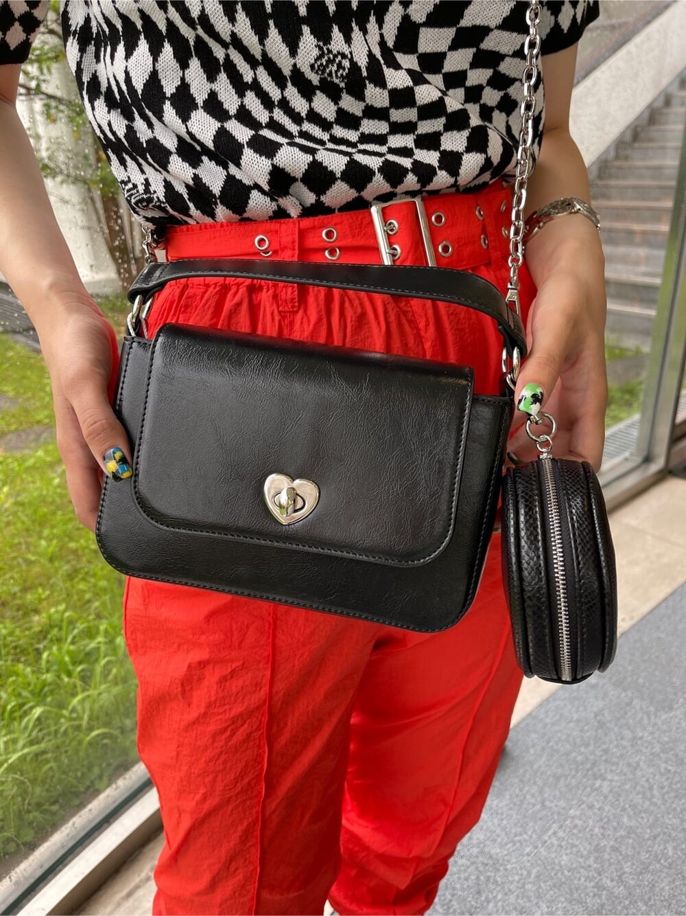 ブラック系のブーツ、ブラック系のニット/セーター、ブラック系のハンドバッグを着用したレディースの春コーディネートの7枚目の写真