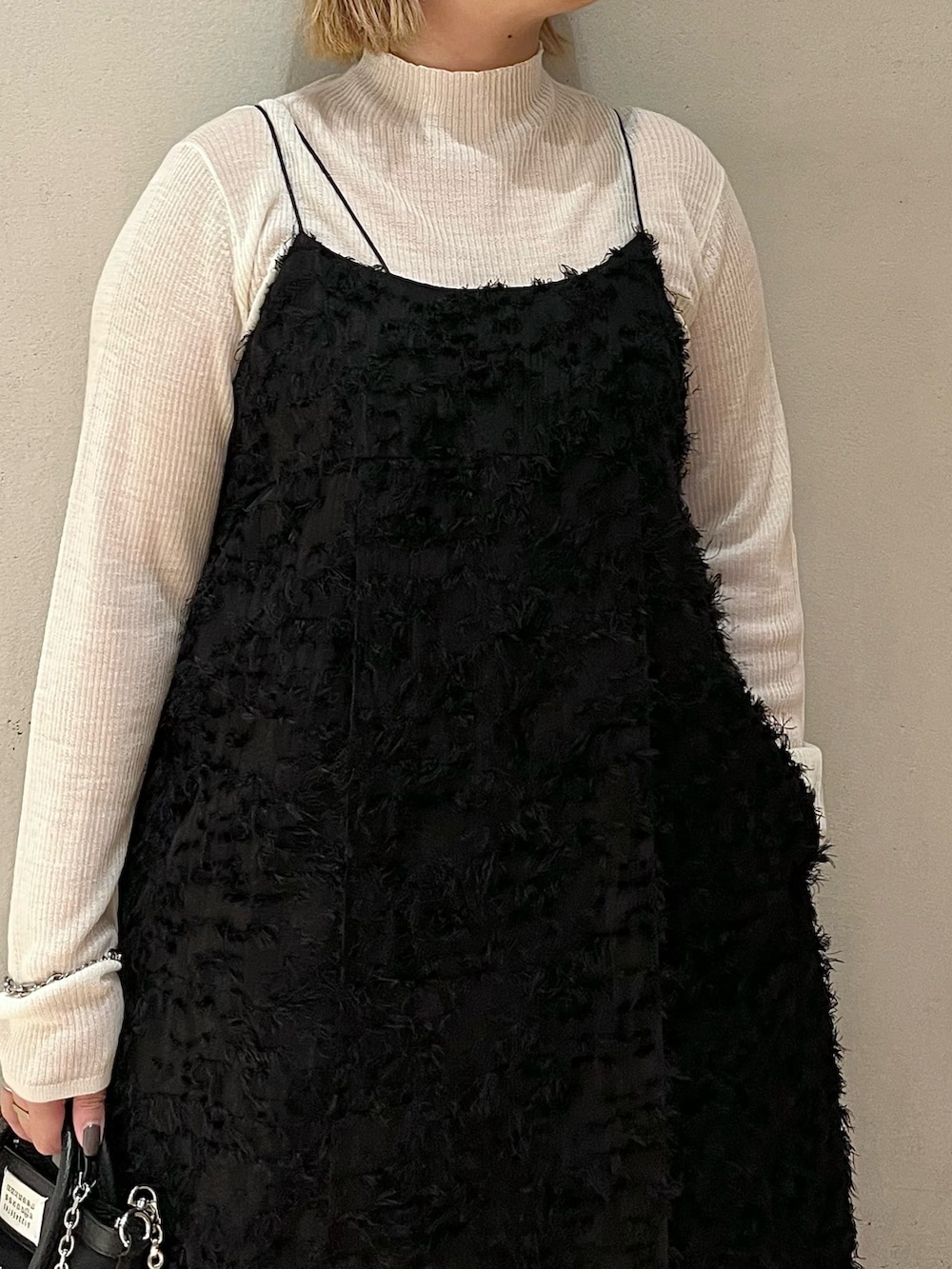 ブラック系のワンピース、ホワイト系のニット/セーターを着用したレディースの秋コーディネートの4枚目の写真