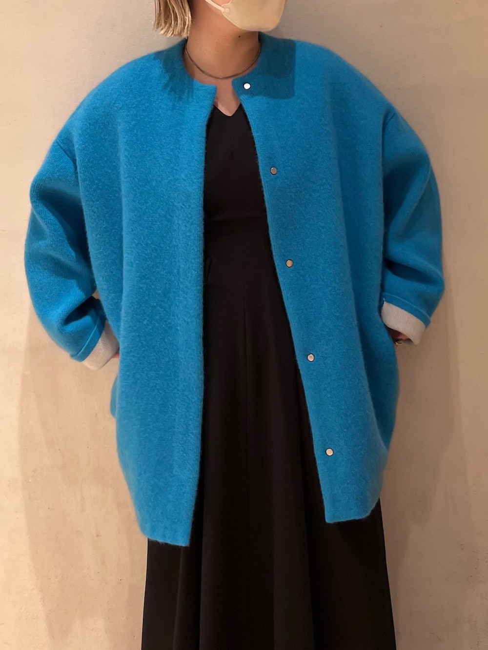 ブルー系のノーカラージャケット、ブラック系のワンピース、ブラック系のスニーカーを着用したレディースの夏コーディネートの6枚目の写真