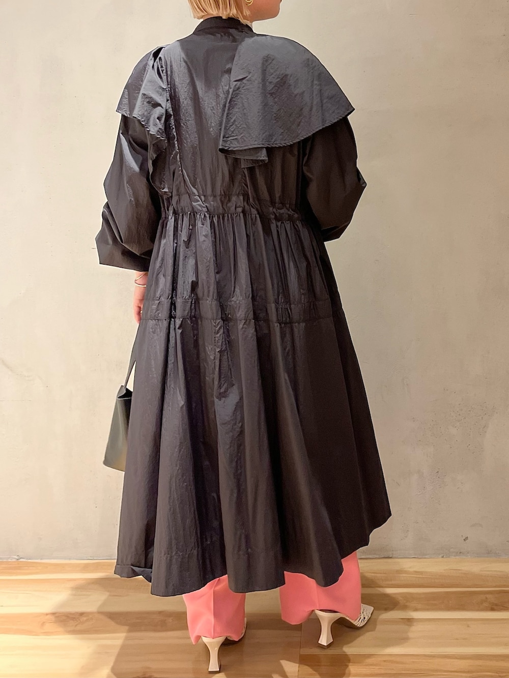 ブラック系のハンドバッグ、ホワイト系のニット/セーター、ピンク系のその他パンツを着用したレディースの冬コーディネートの3枚目の写真