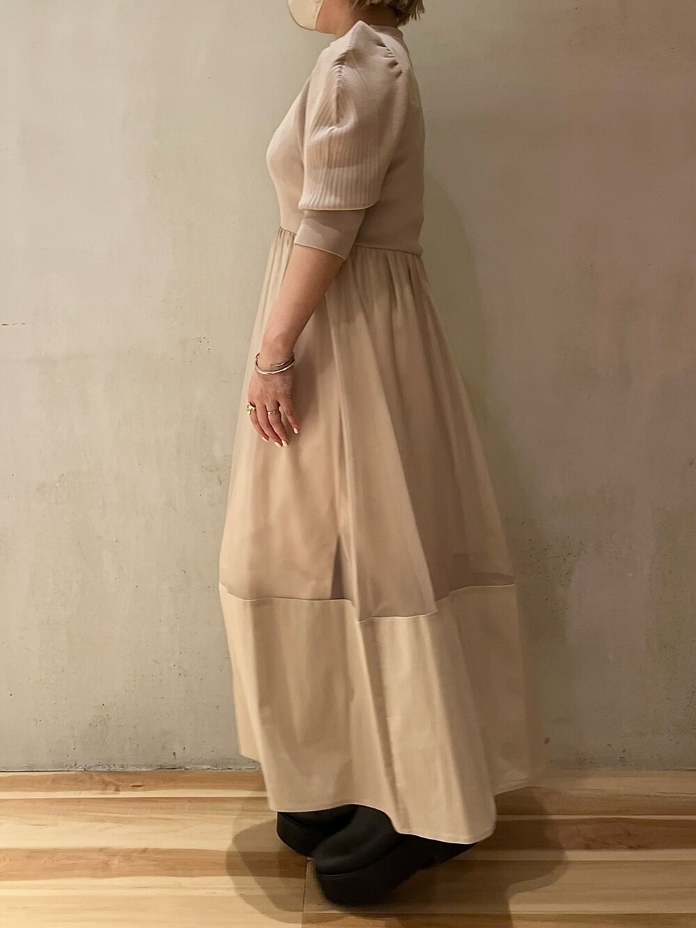 ベージュ系のワンピース、シルバー系のネックレスを着用したレディースの春コーディネートの2枚目の写真