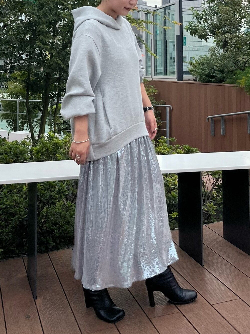 ブラウン系のカーディガン/ボレロ、グレー系のワンピース、ブラック系のブーツを着用したレディースの秋コーディネートの8枚目の写真