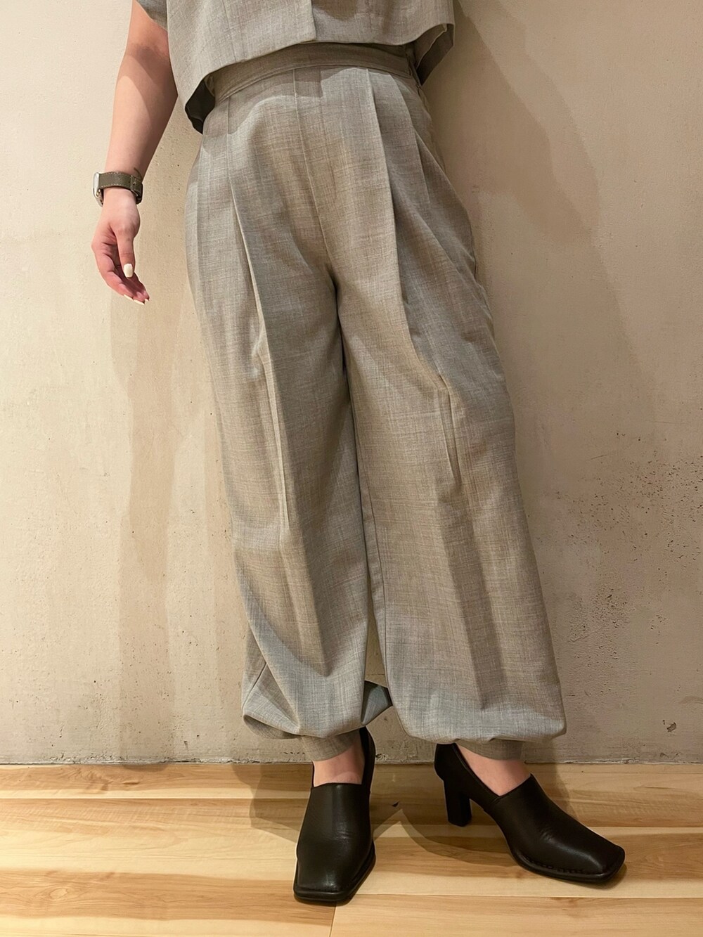 グレー系のテーラードジャケット、グレー系のスラックス、ブラック系のパンプスを着用したレディースの春コーディネートの8枚目の写真