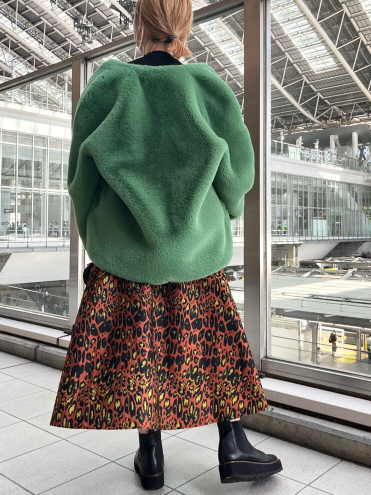 ブラック系のニット/セーター、ホワイト系のショルダーバッグ、グリーン系のノーカラーコートを着用したレディースの夏コーディネートの4枚目の写真