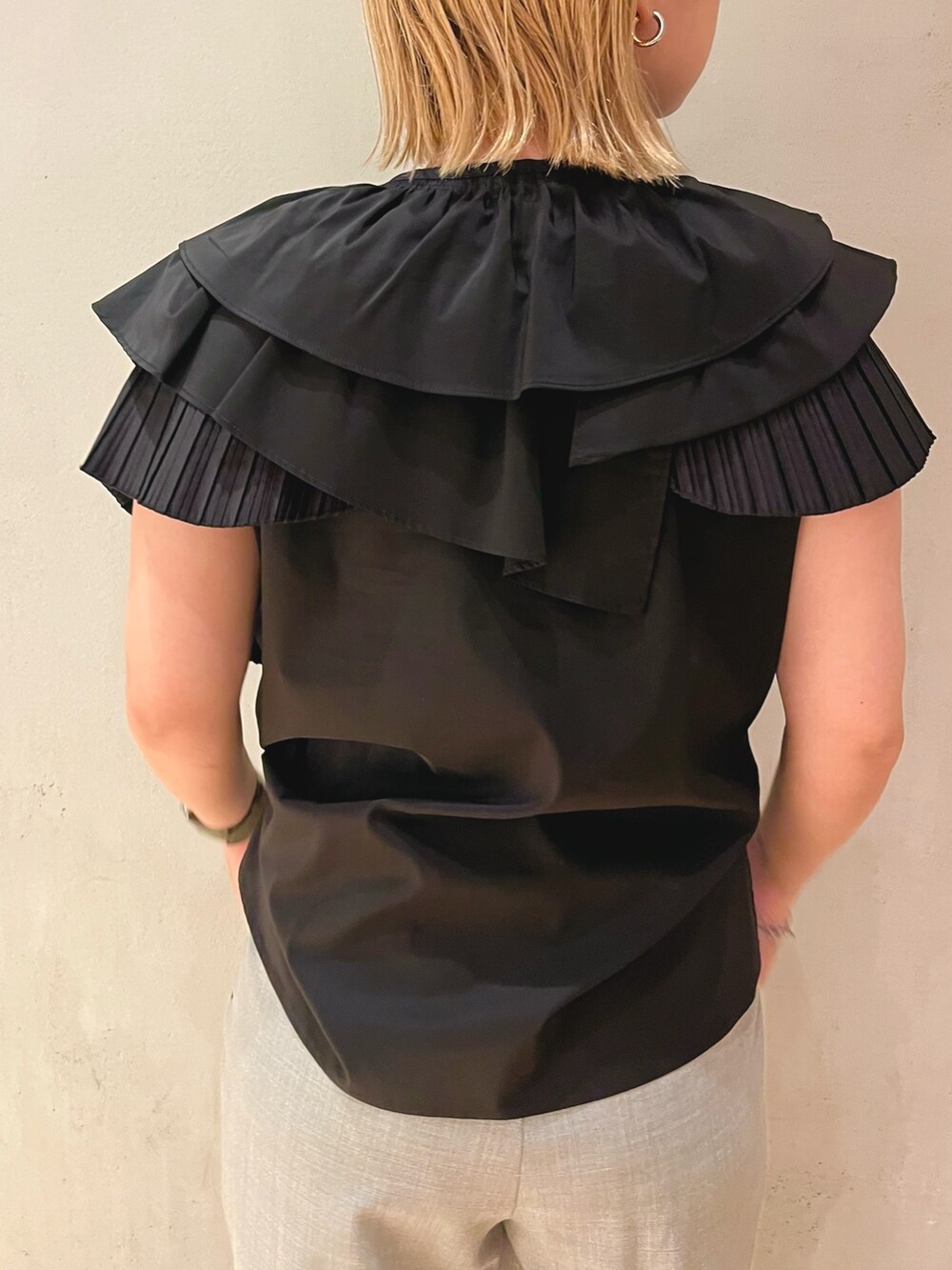 ブラック系のシャツ/ブラウス、グレー系のスラックス、ブラック系のショルダーバッグを着用したレディースの夏コーディネートの6枚目の写真