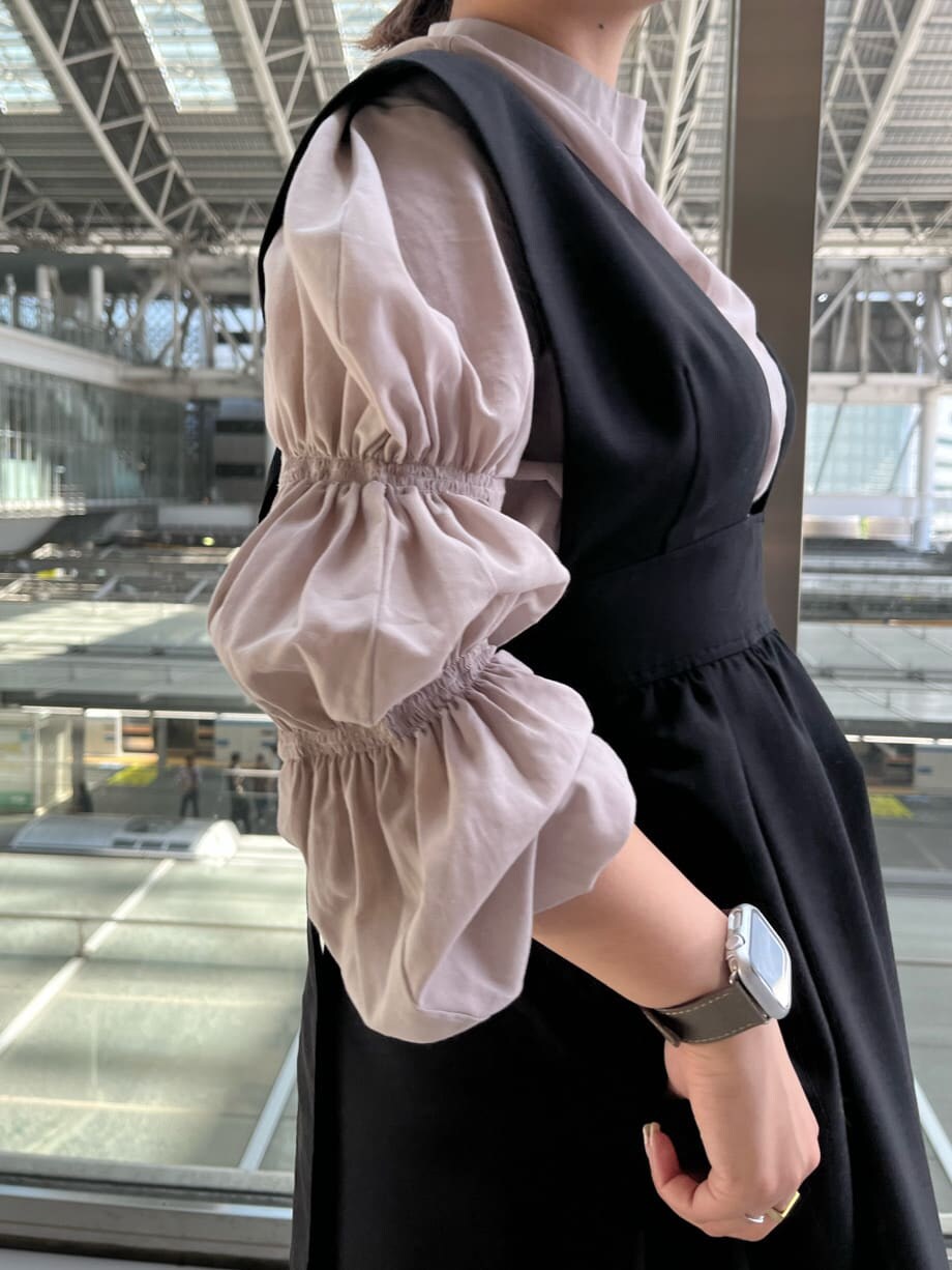 ホワイト系のショルダーバッグ、ベージュ系のシャツ/ブラウス、ブラウン系のブーツを着用したレディースの夏コーディネートの5枚目の写真