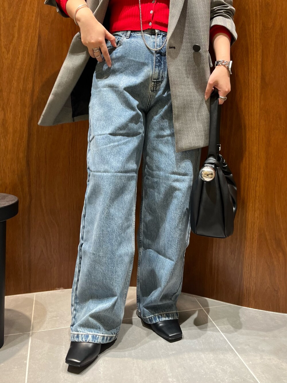 ブラック系のテーラードジャケット、レッド系のカーディガン/ボレロ、ブラック系のハンドバッグを着用したレディースの秋コーディネートの7枚目の写真