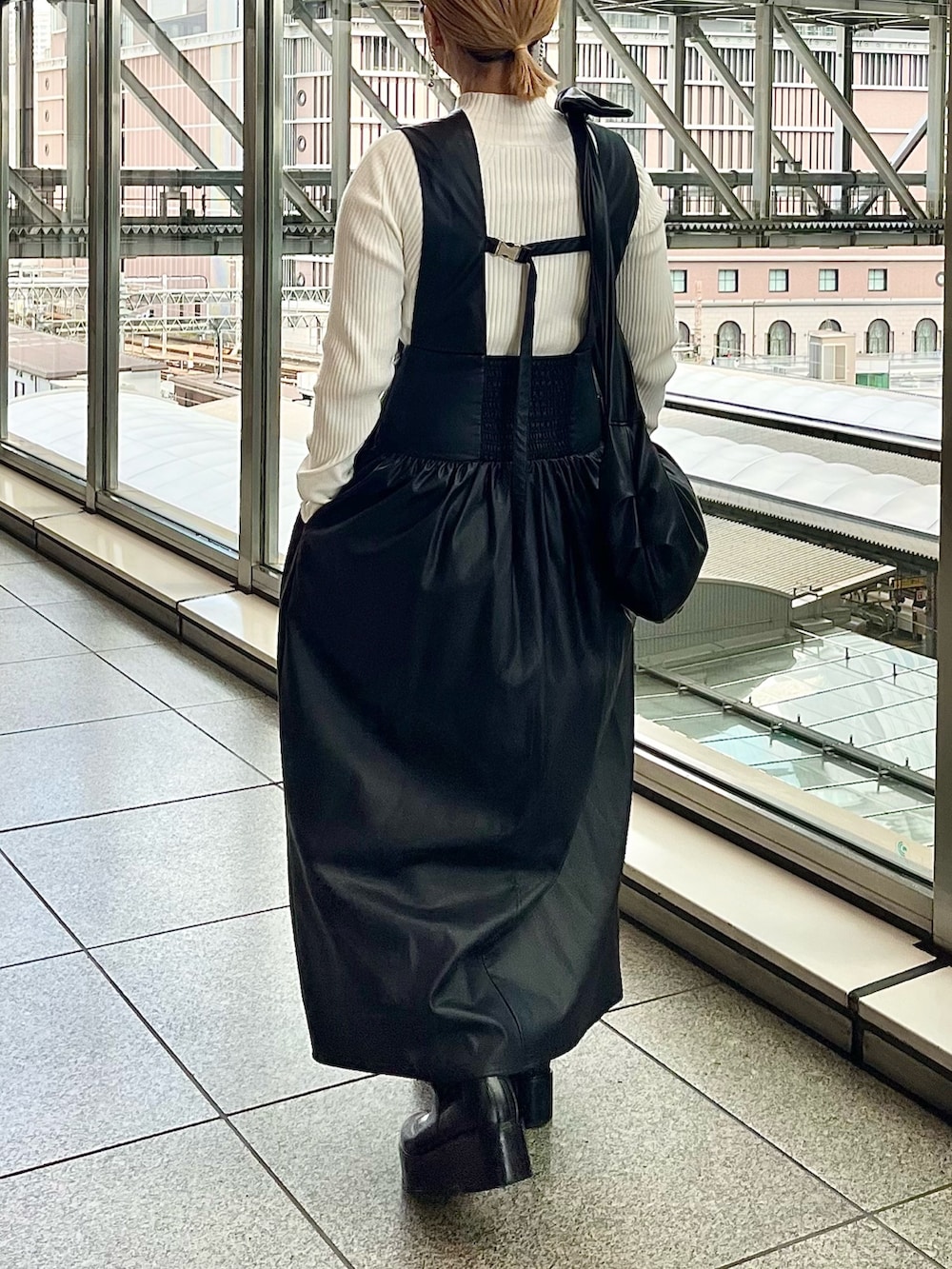 グレー系のノーカラージャケット、ブラック系のジャンパースカート、ホワイト系のニット/セーターを着用したレディースの秋コーディネートの6枚目の写真