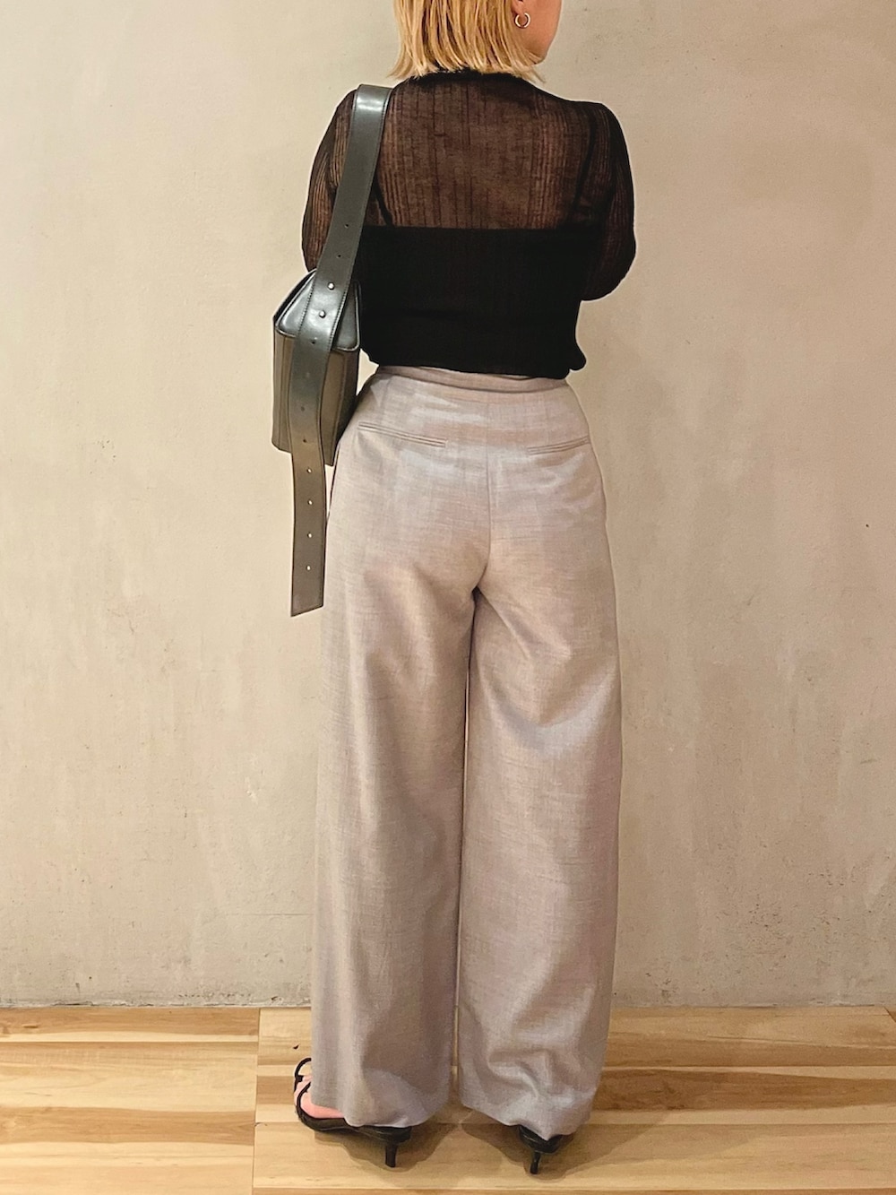 ブラック系のニット/セーター、グレー系のその他パンツ、ブラック系のショルダーバッグを着用したレディースの秋コーディネートの3枚目の写真