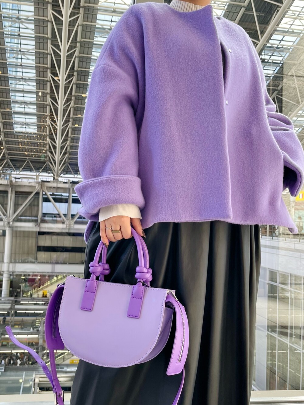 パープル系のノーカラージャケット、ブラック系のジャンパースカート、ホワイト系のニット/セーターを着用したレディースの秋コーディネートの8枚目の写真